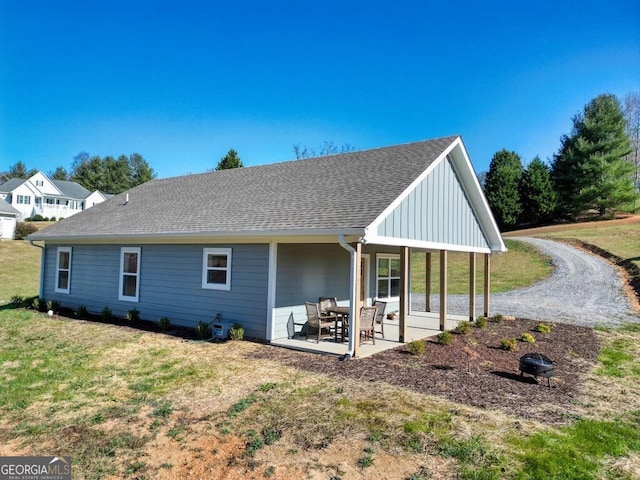 rear view of property with a patio area and a yard