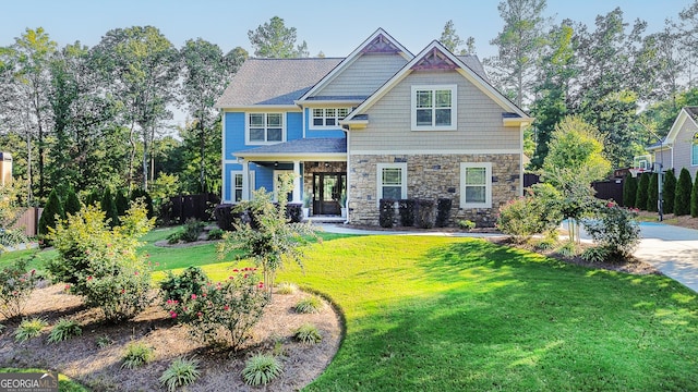 craftsman inspired home with a front lawn