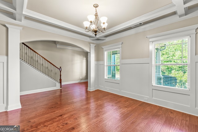 interior space featuring hardwood / wood-style floors, plenty of natural light, ornamental molding, and an inviting chandelier