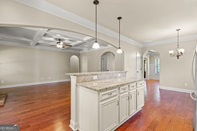 kitchen with pendant lighting, a center island, coffered ceiling, white cabinets, and dark hardwood / wood-style flooring