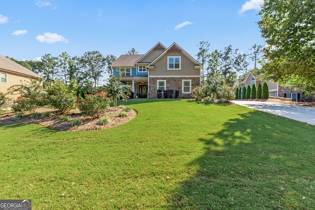 craftsman-style house with a front lawn