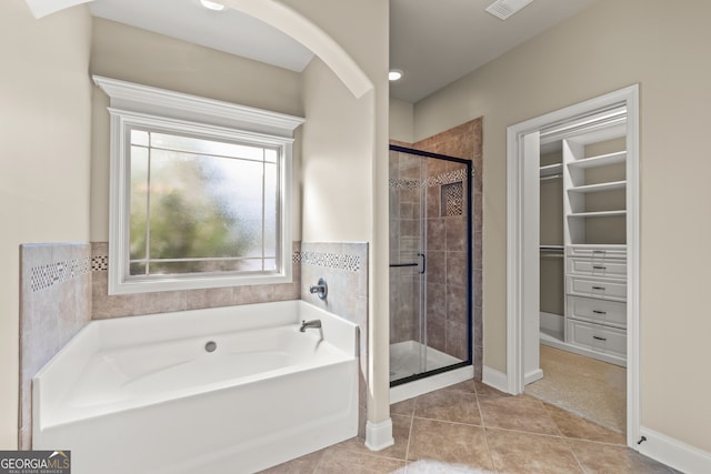 bathroom with tile patterned floors and plus walk in shower