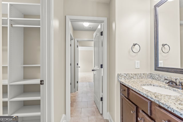 bathroom with tile patterned flooring and vanity