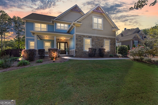 craftsman house with a yard