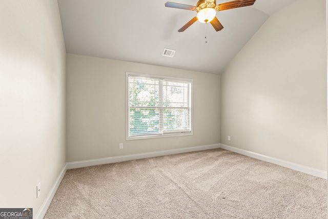 unfurnished room with ceiling fan, carpet floors, and lofted ceiling