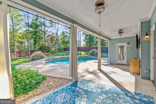 view of swimming pool featuring a yard and a patio