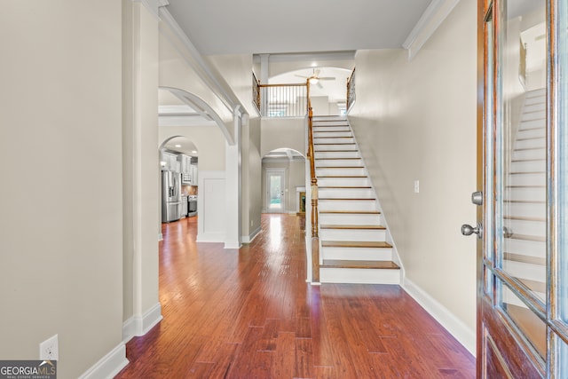 entrance foyer featuring ceiling fan, dark hardwood / wood-style flooring, and ornamental molding