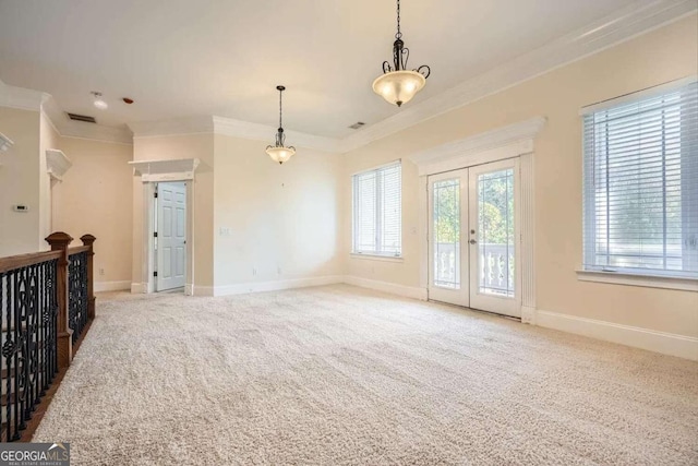 carpeted spare room with french doors and ornamental molding