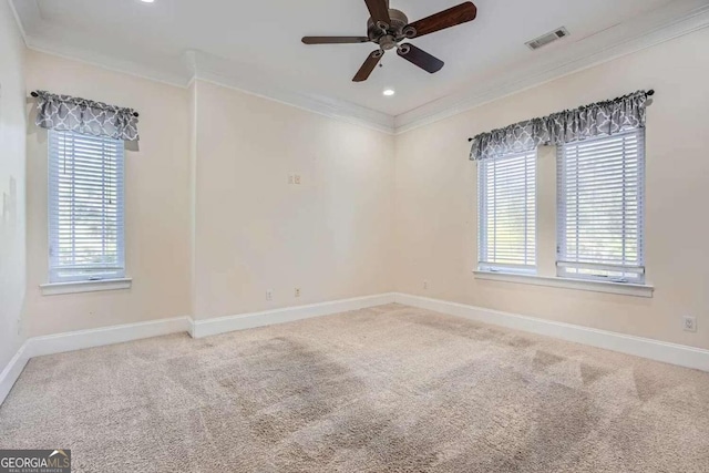 carpeted empty room featuring ceiling fan and crown molding