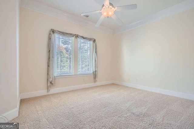 carpeted empty room featuring ceiling fan and ornamental molding