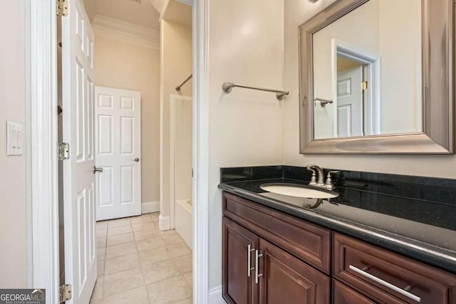 bathroom featuring tile patterned floors, vanity, bathtub / shower combination, and ornamental molding