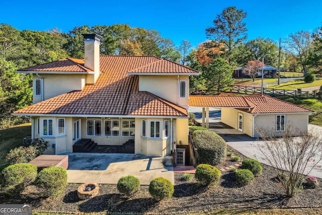 rear view of property featuring a patio area