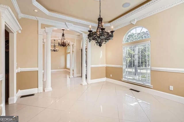 unfurnished dining area featuring light tile patterned flooring, ornate columns, ornamental molding, and a notable chandelier