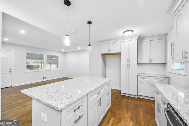 kitchen with dark hardwood / wood-style floors, a kitchen island, white cabinetry, and hanging light fixtures