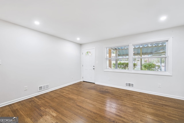 spare room with dark wood-type flooring