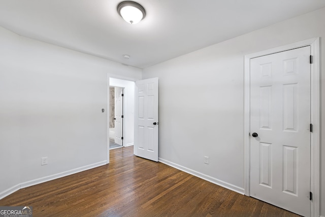 unfurnished bedroom featuring dark wood-type flooring