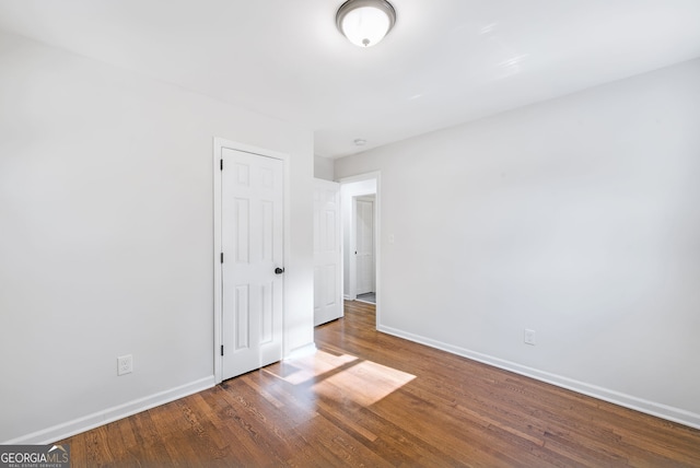 spare room with dark hardwood / wood-style flooring