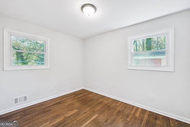 empty room featuring hardwood / wood-style flooring and a healthy amount of sunlight