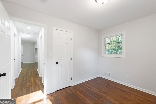 empty room with dark wood-type flooring