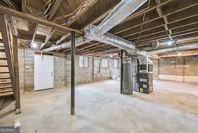 basement featuring heating unit and water heater