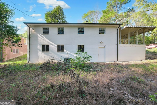 rear view of property with cooling unit