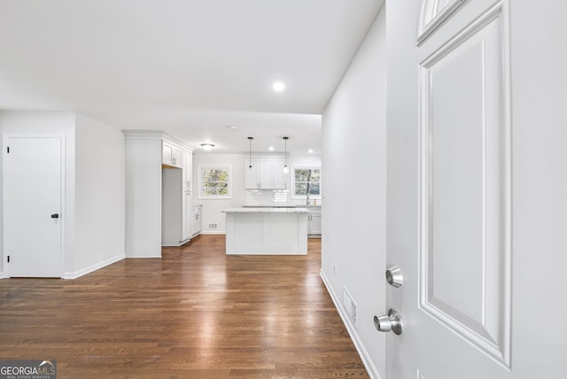 unfurnished living room with dark hardwood / wood-style flooring