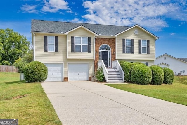 split foyer home with a garage and a front lawn