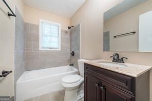 full bathroom with vanity, toilet, and tiled shower / bath