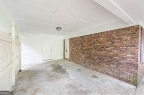 interior space featuring brick wall and concrete floors