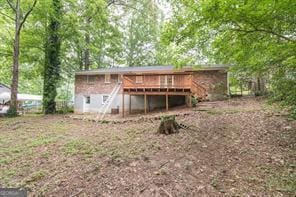 rear view of property featuring a deck