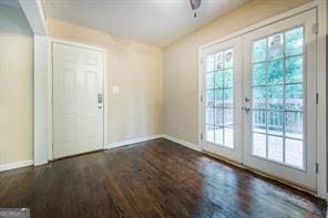 doorway with ceiling fan, dark wood-type flooring, and french doors