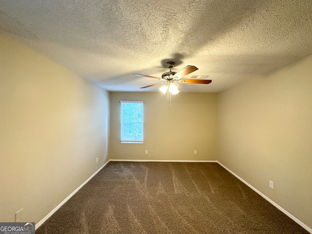 empty room with carpet flooring, ceiling fan, and a textured ceiling