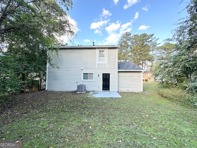 back of property with a yard, a patio, and central AC unit