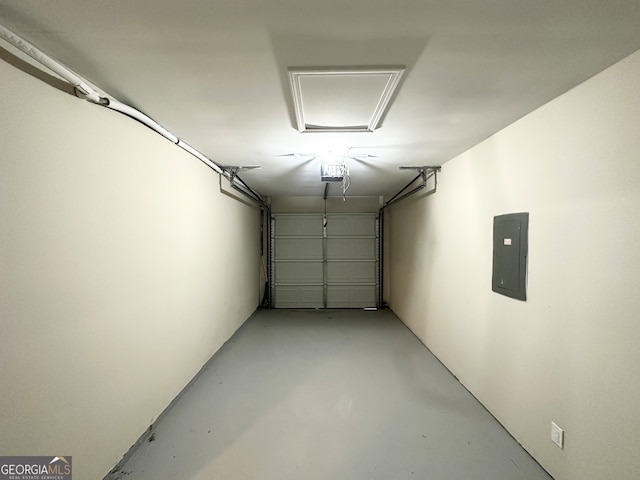 garage featuring electric panel and a garage door opener