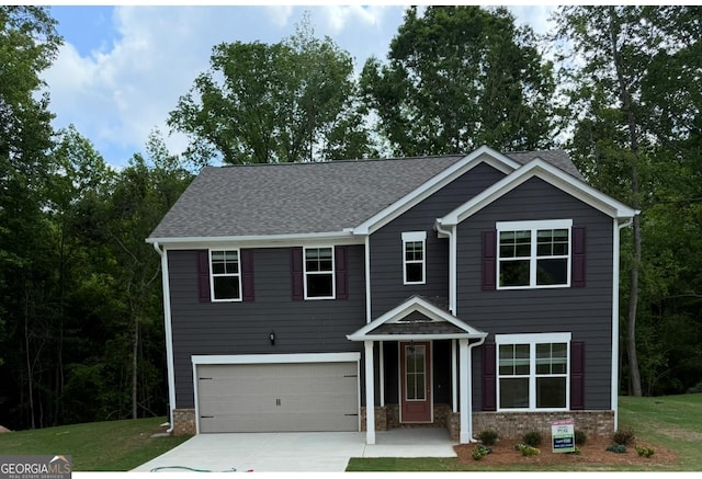 1091 Boulder Dr, Gray, GA 31032 - view of front of house featuring a garage, concrete driveway, a front lawn, and roof with shingles