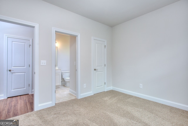1091 Boulder Dr, Gray, GA 31032 - unfurnished bedroom featuring light carpet, baseboards, and ensuite bathroom