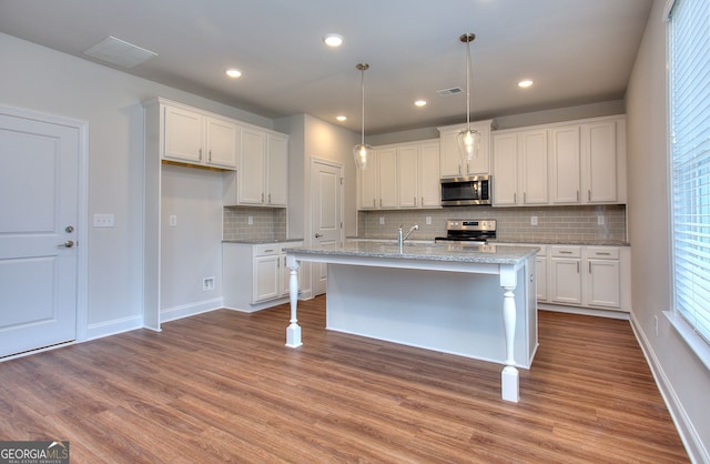 1091 Boulder Dr, Gray, GA 31032 - kitchen featuring appliances with stainless steel finishes, white cabinetry, tasteful backsplash, and recessed lighting