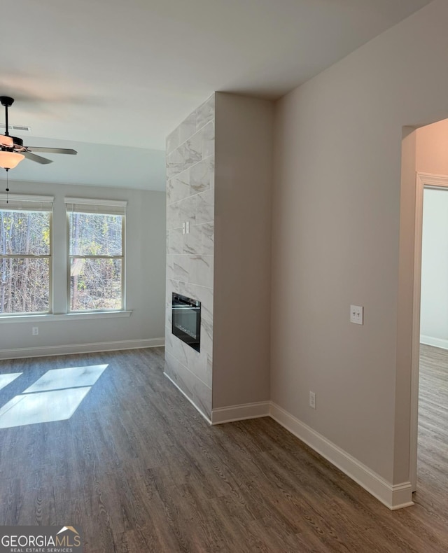 1091 Boulder Dr, Gray, GA 31032 - unfurnished living room with dark wood-style flooring, baseboards, and a ceiling fan