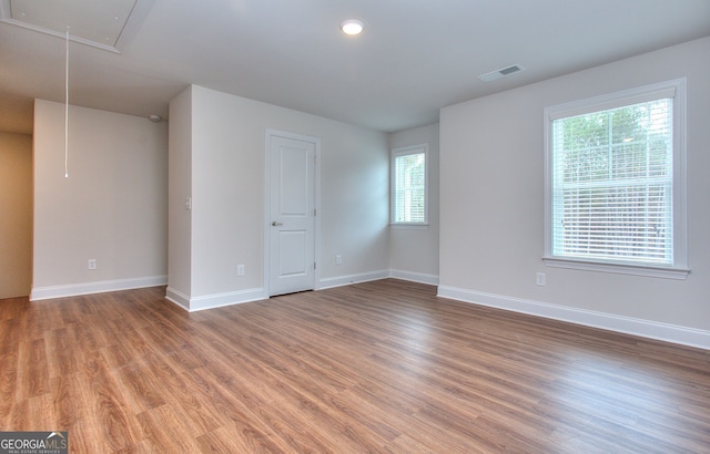 1091 Boulder Dr, Gray, GA 31032 - spare room featuring attic access, light wood-style flooring, and baseboards