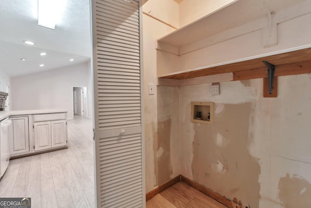 washroom featuring hookup for a washing machine and light hardwood / wood-style floors