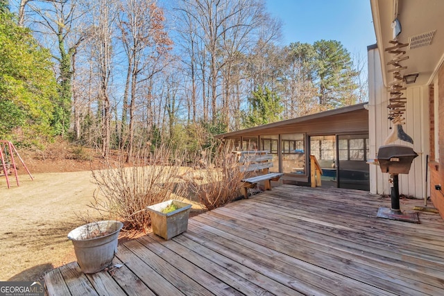 wooden terrace featuring a sunroom