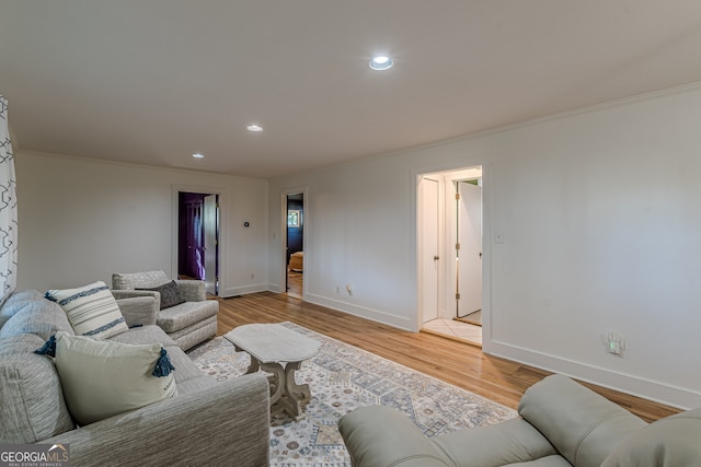 living room featuring light hardwood / wood-style flooring and crown molding