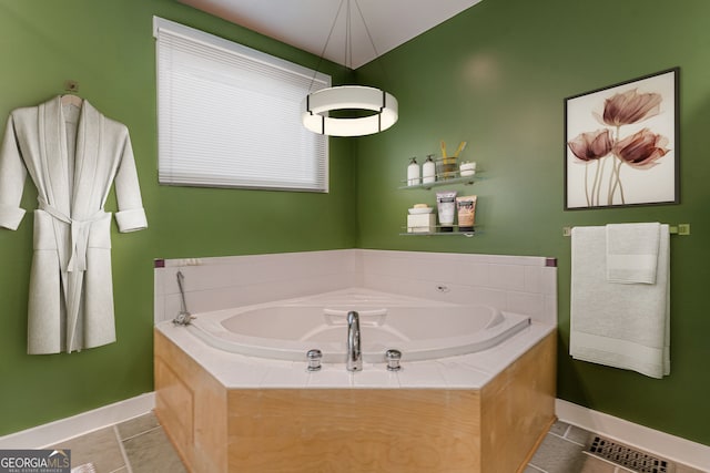 bathroom featuring a relaxing tiled tub and tile patterned floors