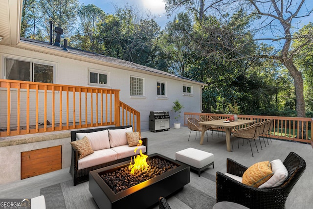 deck with grilling area and an outdoor living space with a fire pit