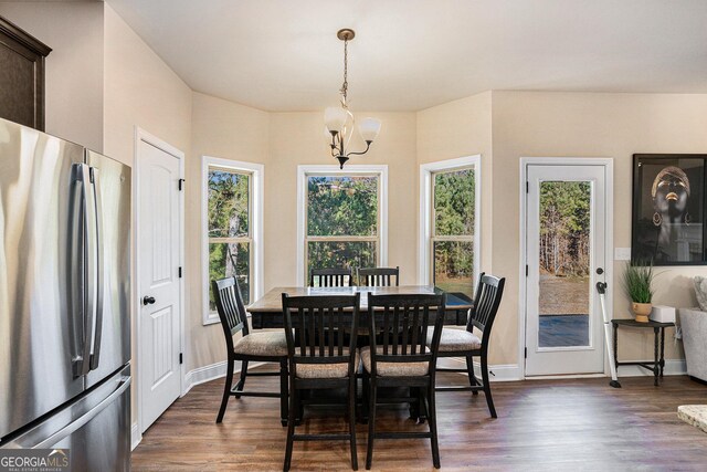 dining area featuring a chandelier and dark hardwood / wood-style floors