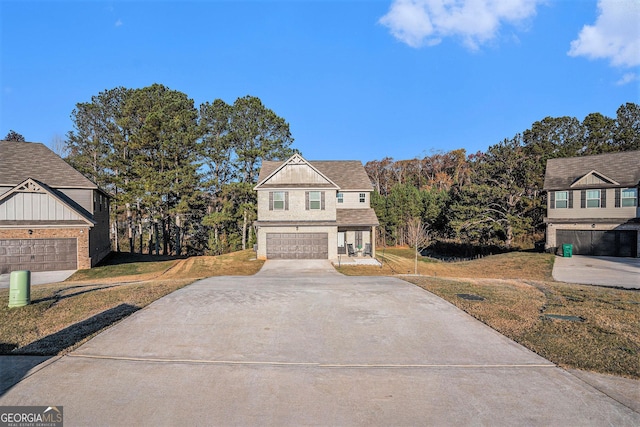 view of front of property with a garage and a front lawn