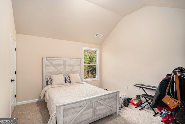 carpeted bedroom with vaulted ceiling