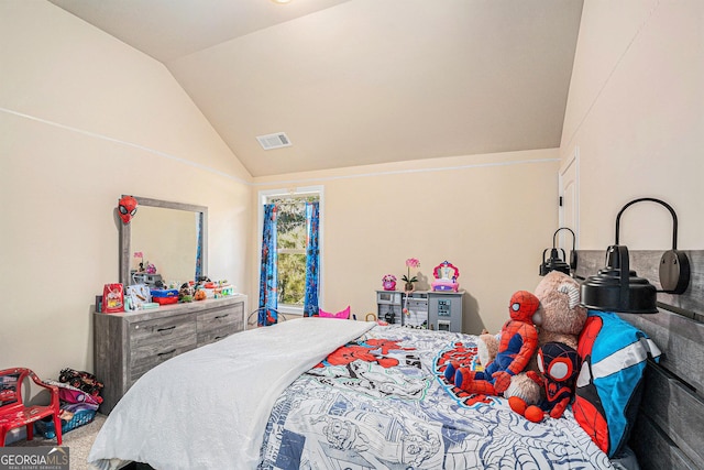 bedroom with carpet floors and lofted ceiling