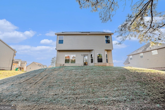 back of house with a yard