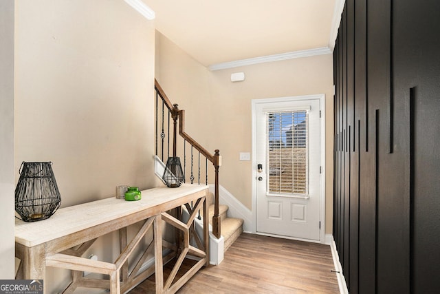 foyer featuring light hardwood / wood-style floors and ornamental molding